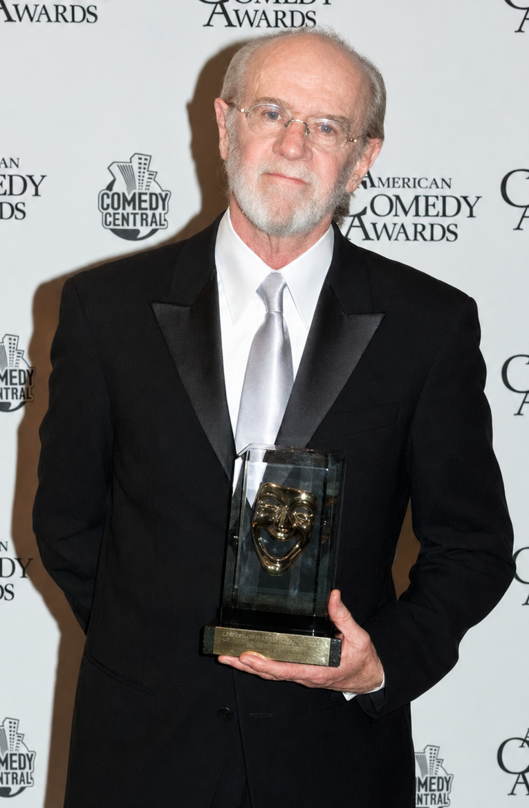 George Carlin holding the American Comedy Awards trophy